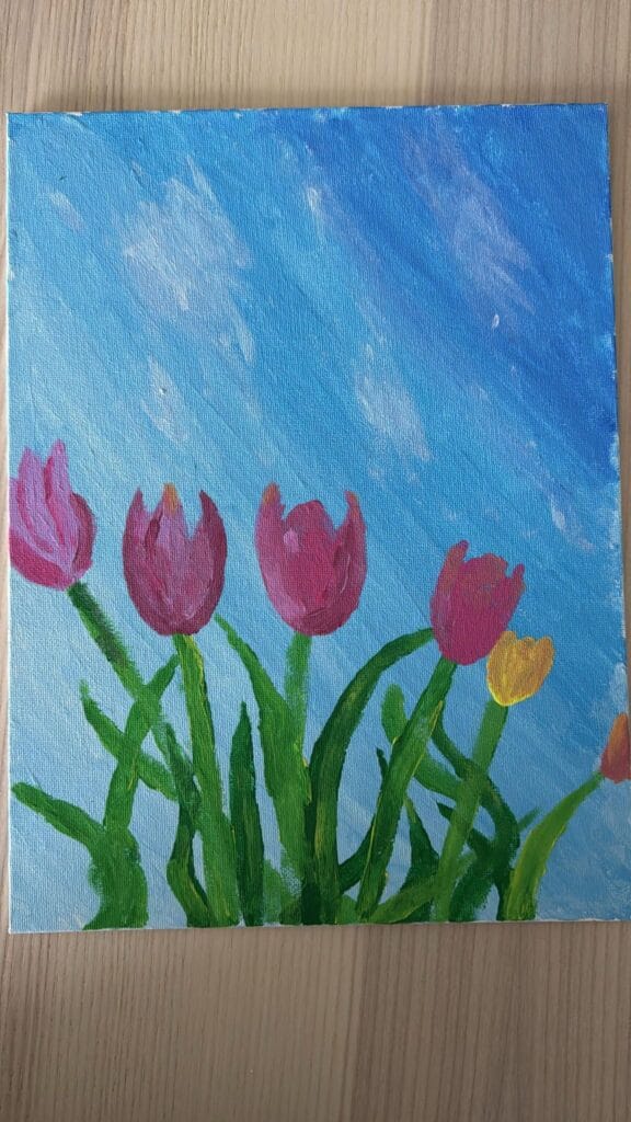 acrylic painting of pink, magenta, and yellow tulips against a blue sky, created at a paint and sip event